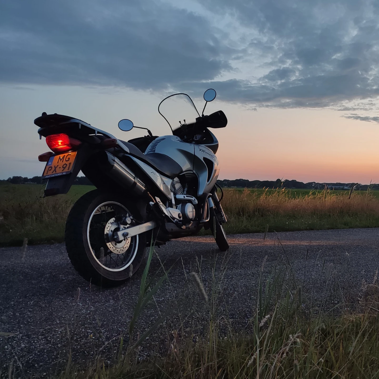 Honda Transalp pictured from the rear at sunset